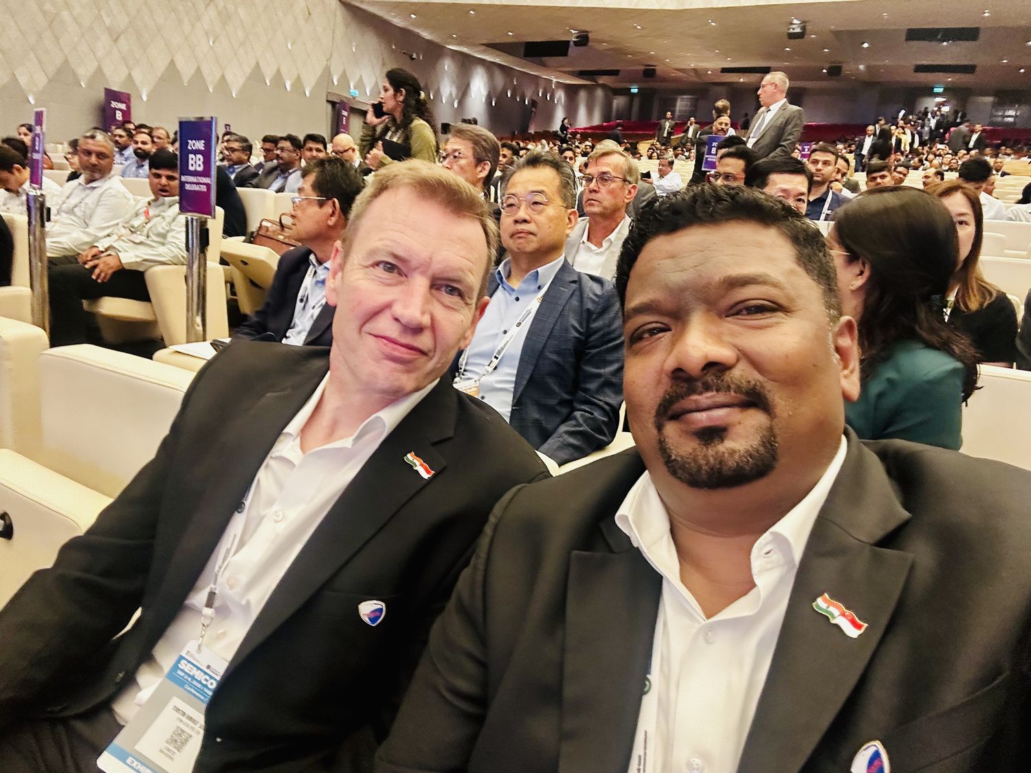 Venkatesh Kumar Pandurengan with an international delegate in a packed conference hall