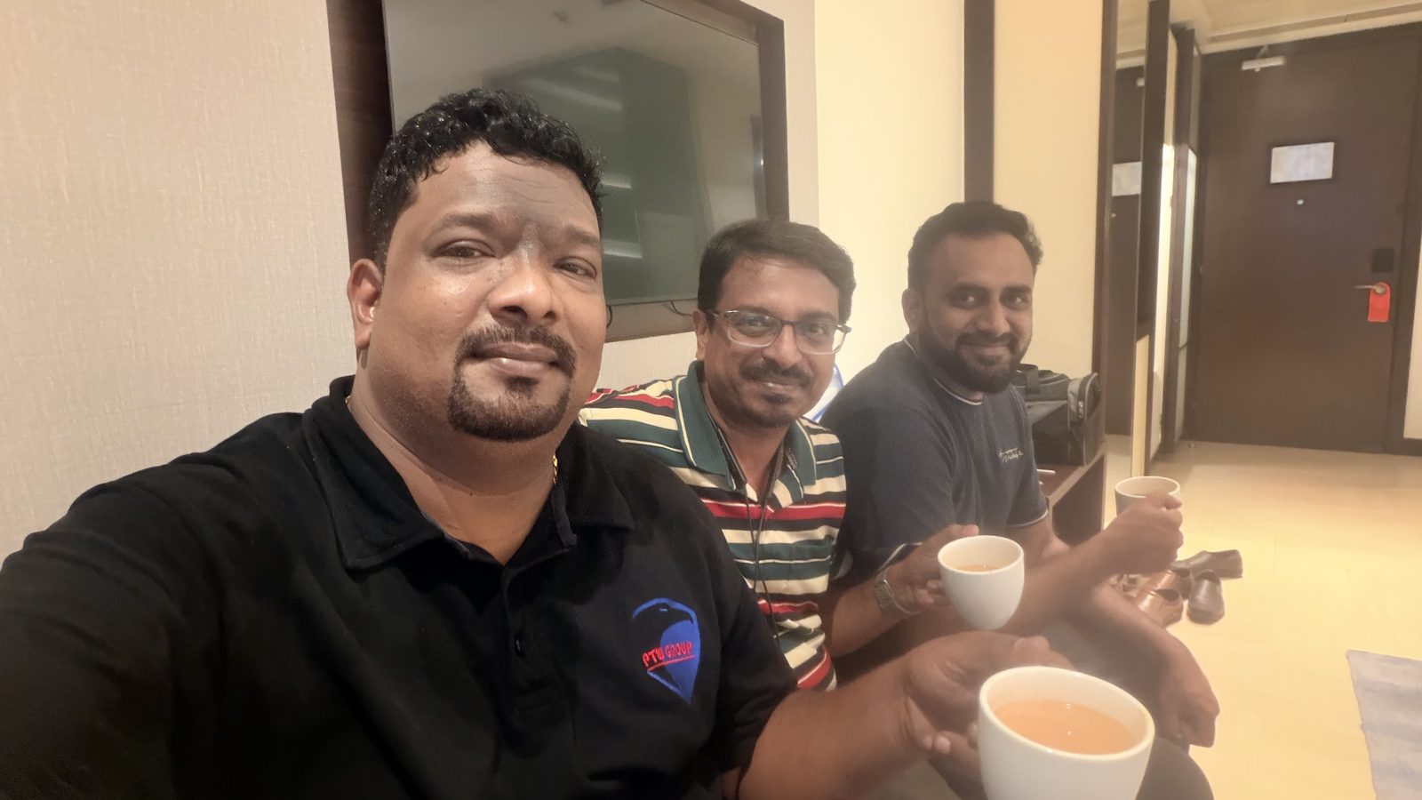 Venkatesh Kumar Pandurengan and two colleagues sitting with cups of chai between sessions at SEMICON India