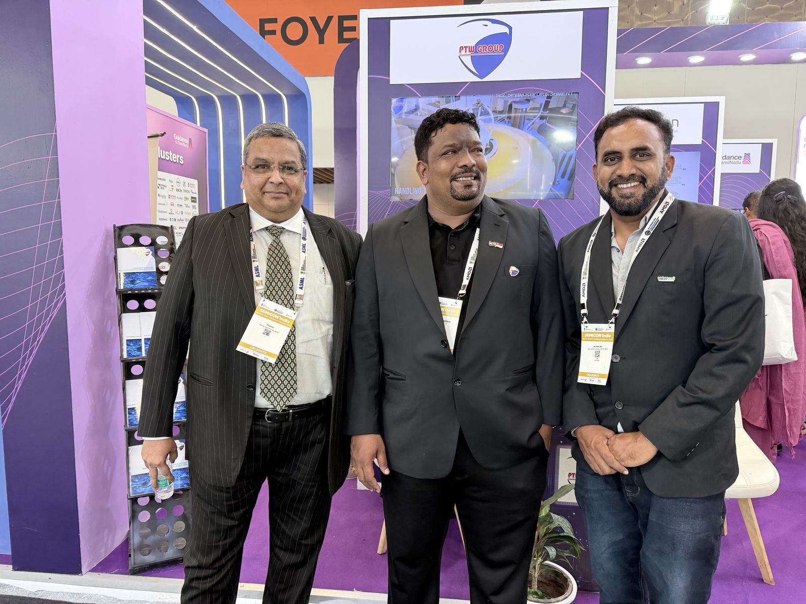 Venkatesh Kumar Pandurengan with two colleagues at an exhibition booth at SEMICON India
