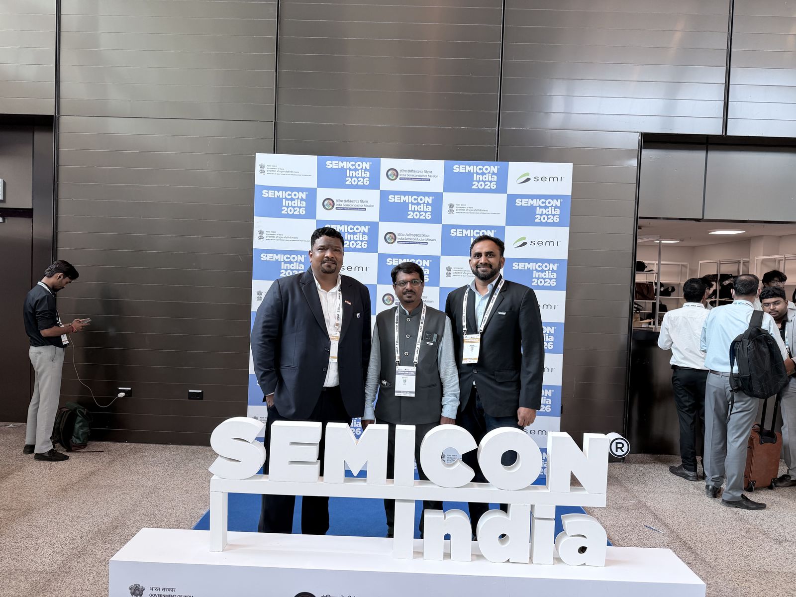 Venkatesh Kumar Pandurengan with colleagues beside the SEMICON India signage